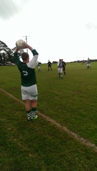 Left back Ciaran O'Neill sends the takes a throw in.